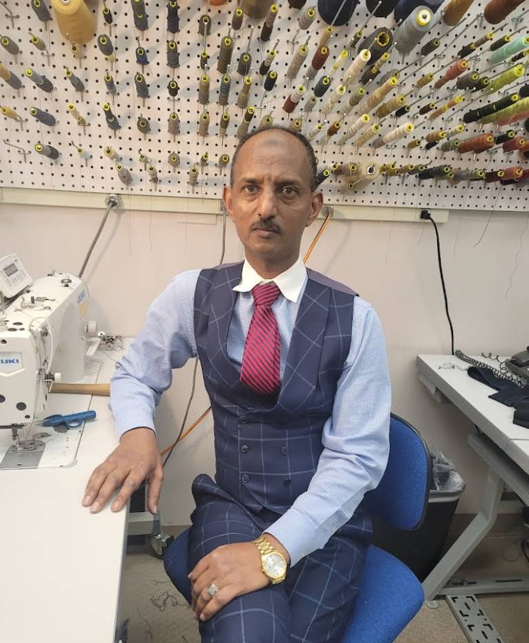 The tailor at work in the 99&rsquo;s Tailoring & Alterations shop in Denver